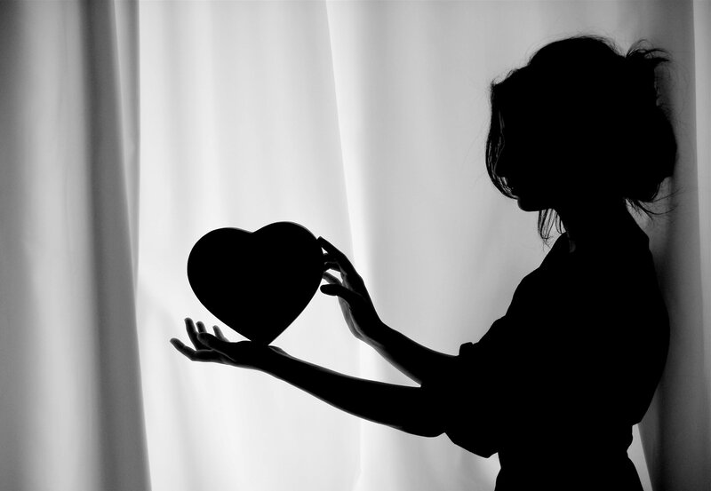 Silhouette of Woman Holding Heart — Black