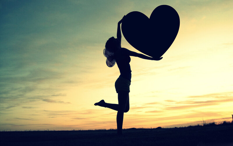 Silhouette of Woman Holding Heart — Yellow, Dramatic, Sunset, Photograph