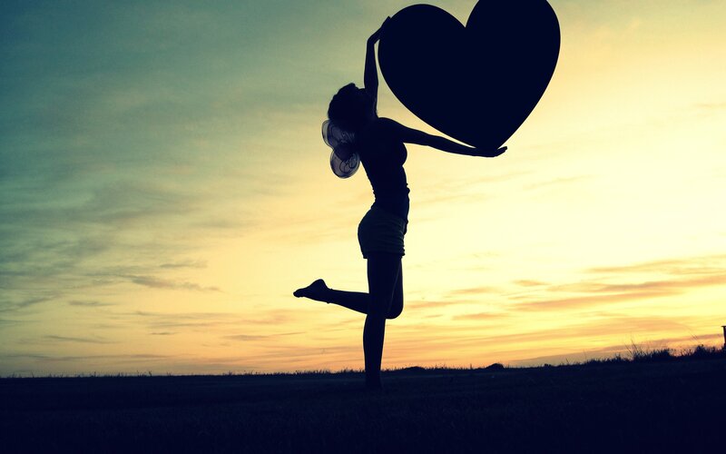 Silhouette of Woman Holding Heart — Yellow, Dramatic, Sunset, Photograph, Wings, Sky