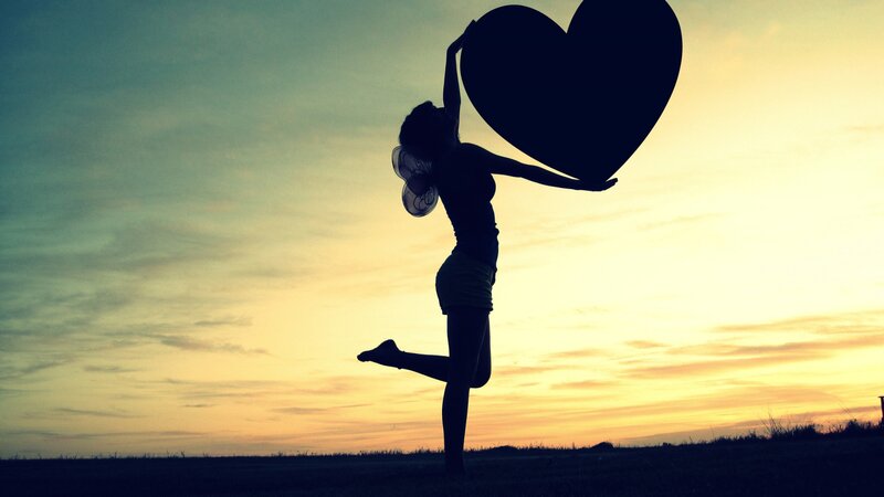 Silhouette of Woman Holding Heart — Yellow, Dramatic, Sunset
