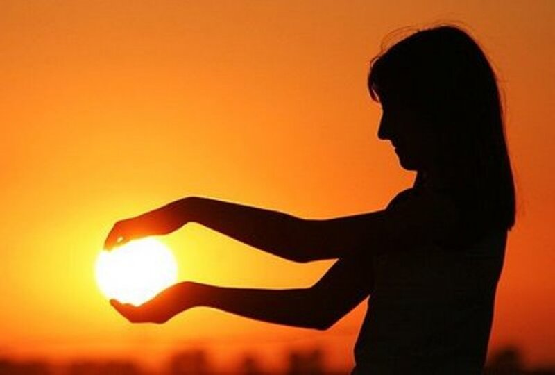 Silhouette of Woman Holding Sun — Orange