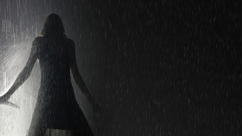 silhouette of woman in rain