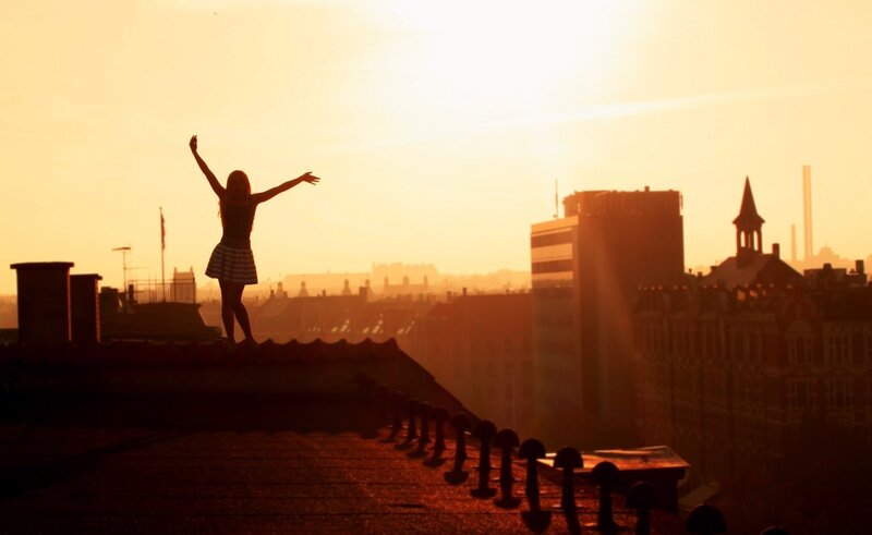 Silhouette of Woman on Roof — Orange