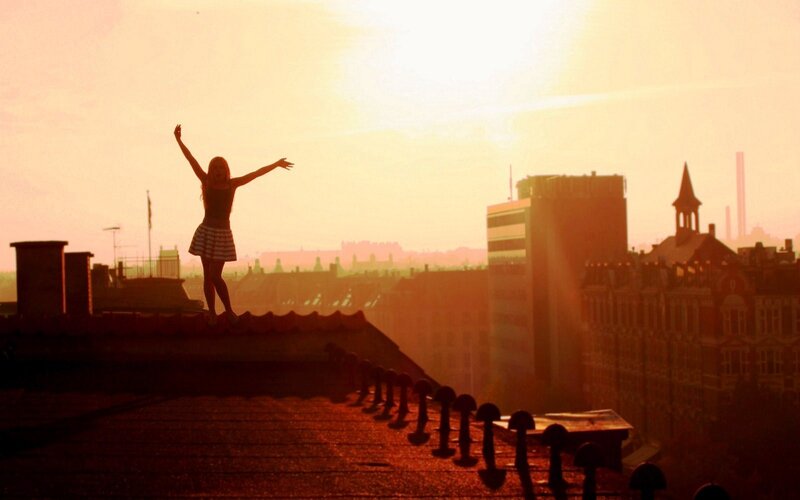 Silhouette of Woman on Roof