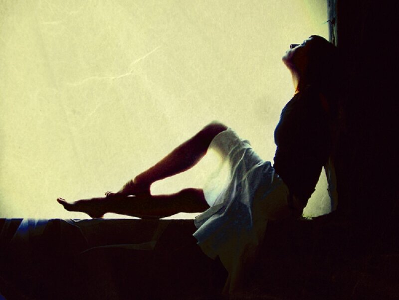 Silhouette of Woman Sitting — Black, Dramatic