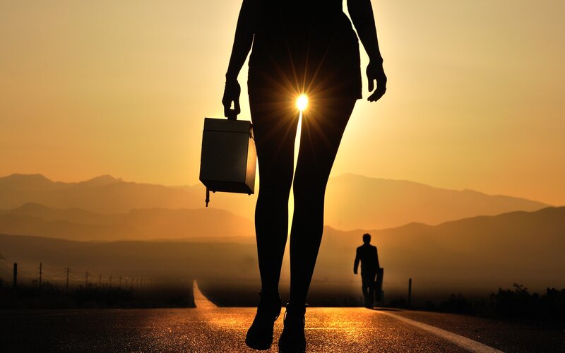 Silhouette of woman walking on road