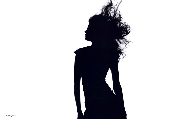 silhouette of woman with wind-blown hair
