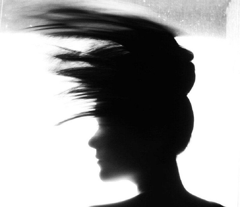 silhouette of woman with wind-blown hair