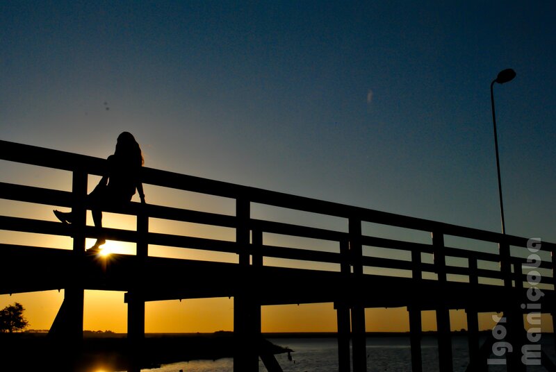 silhouette on a bridge at sunset