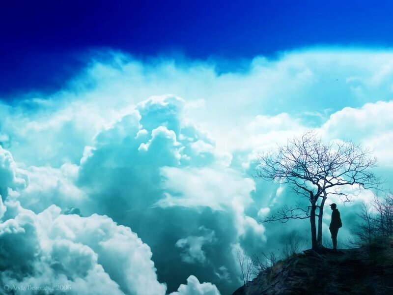 Silhouette on a cliff with clouds