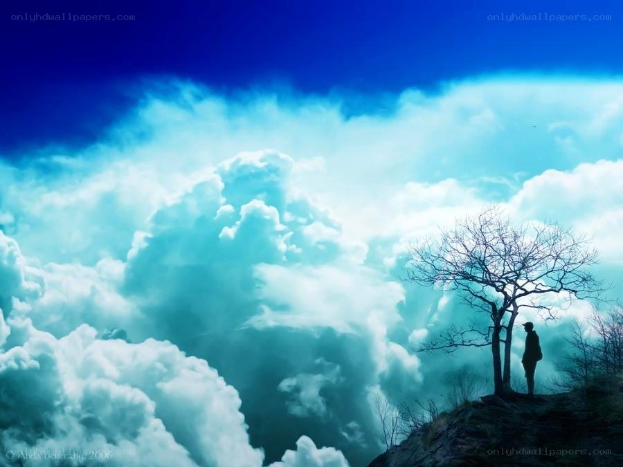 Silhouette on a cliff with clouds