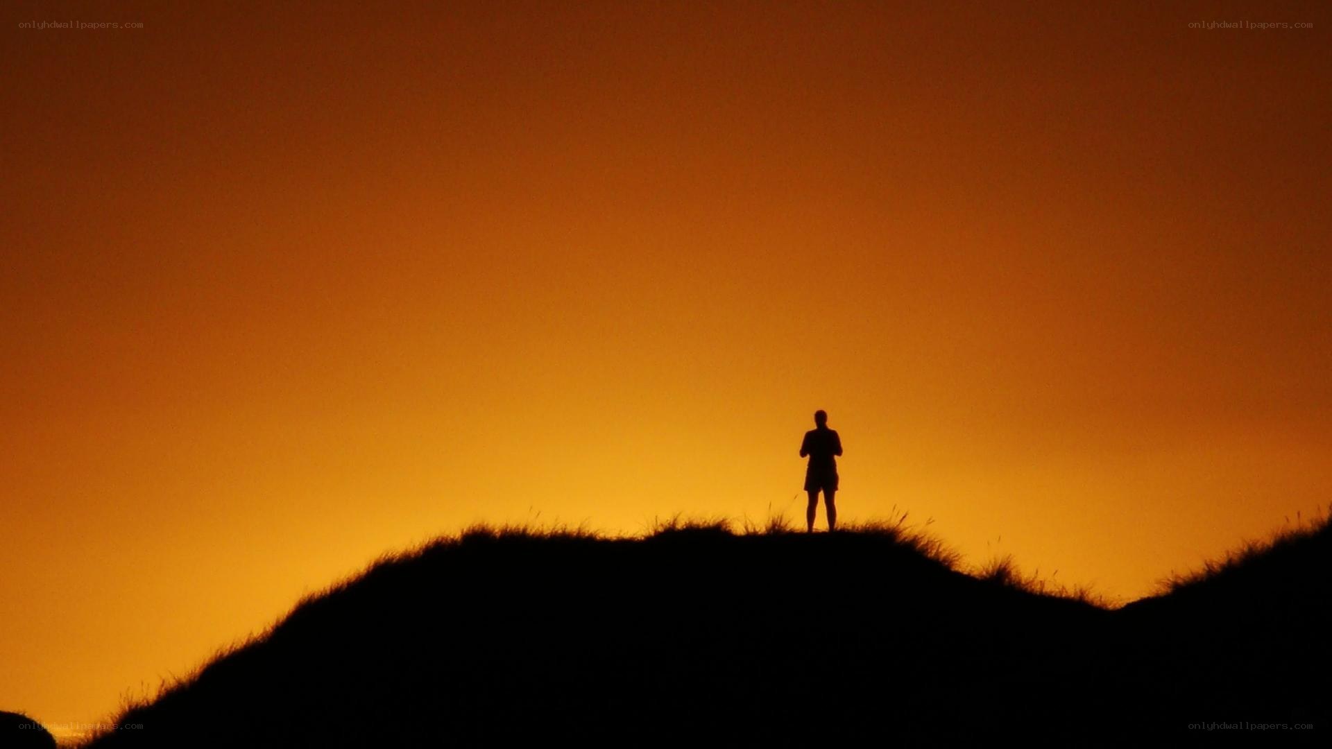silhouette on a hill at sunset