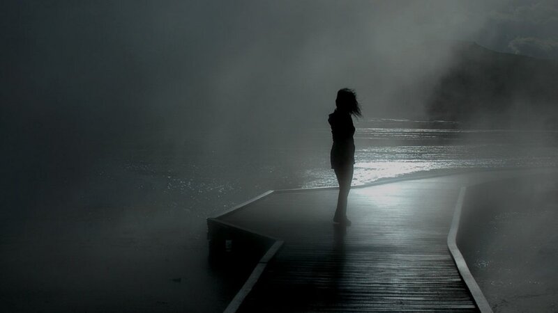 silhouette on a misty pier