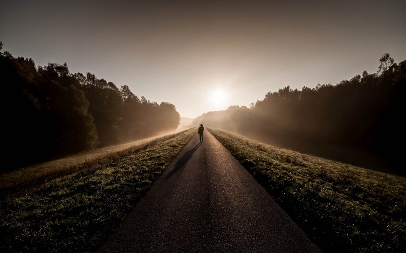 Silhouette on a misty road