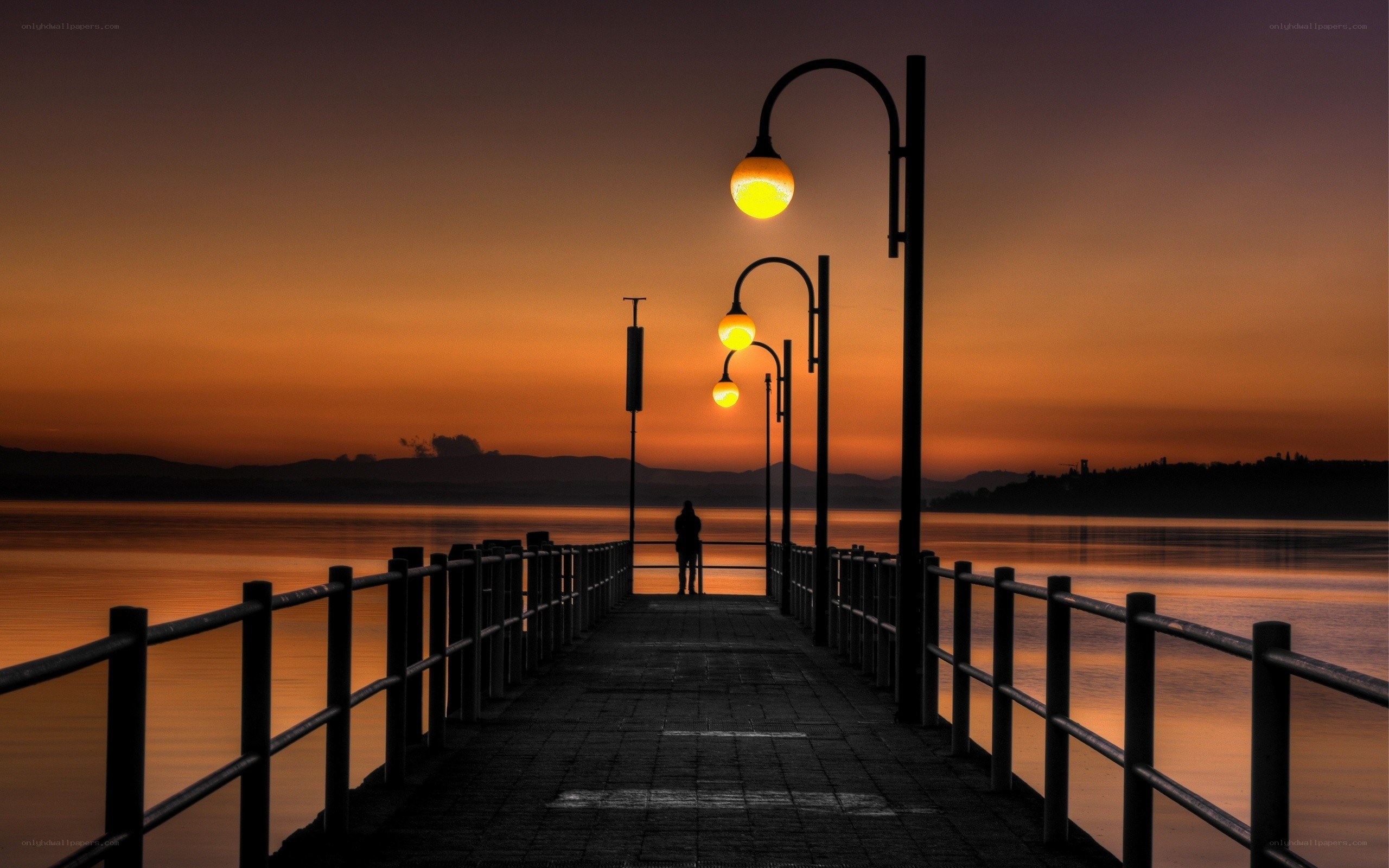 Silhouette on a pier at sunset