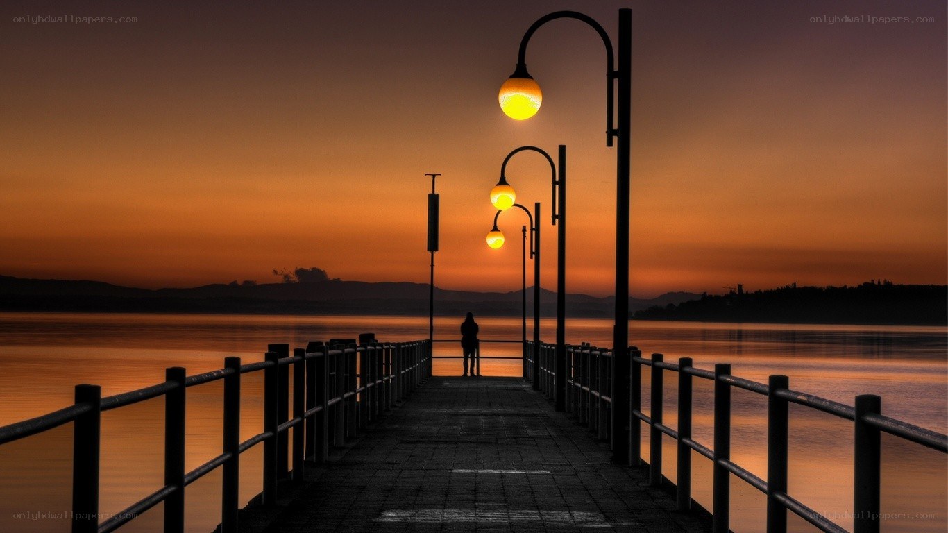 Silhouette on a pier at sunset