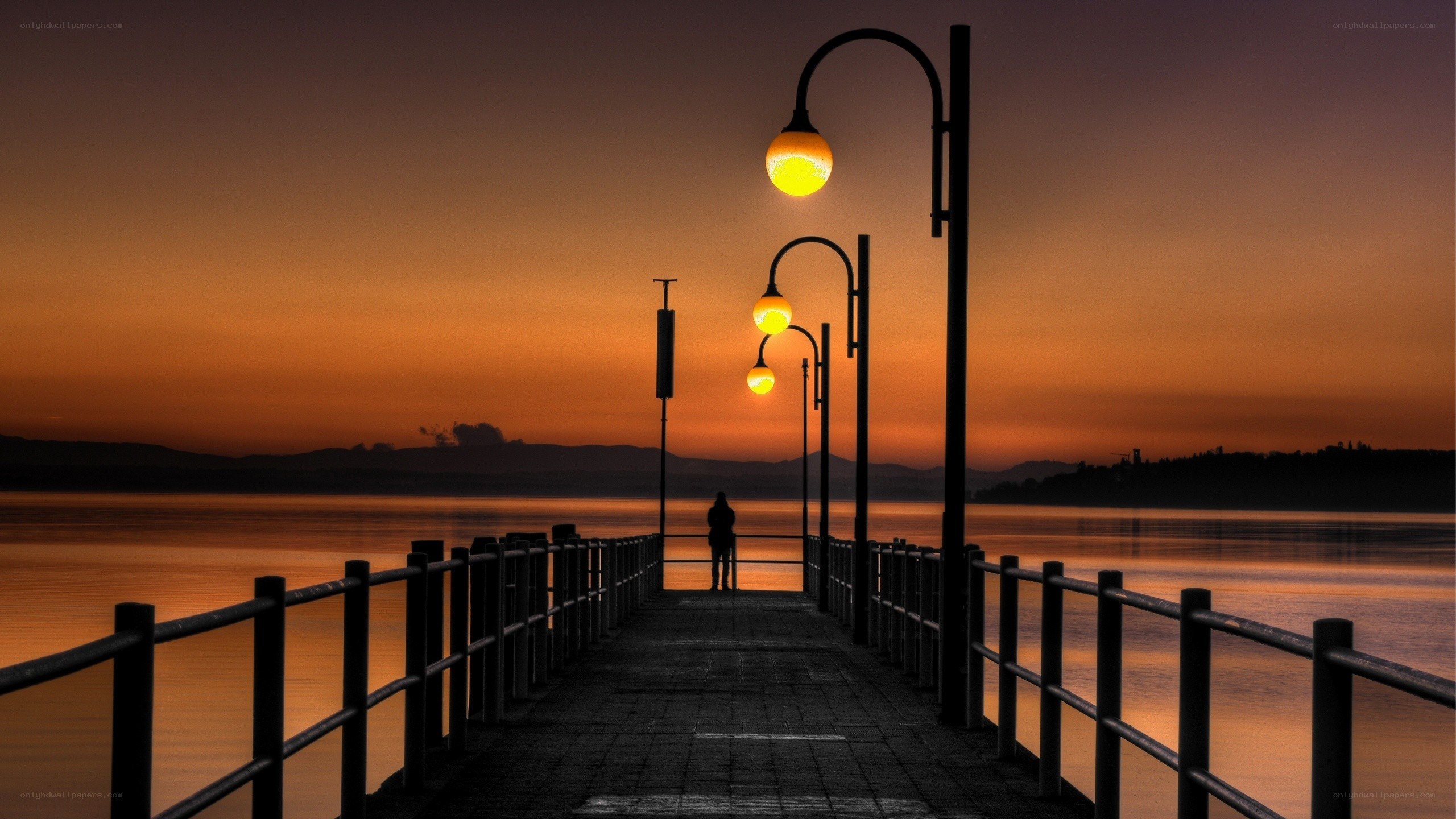 Silhouette on a pier at sunset