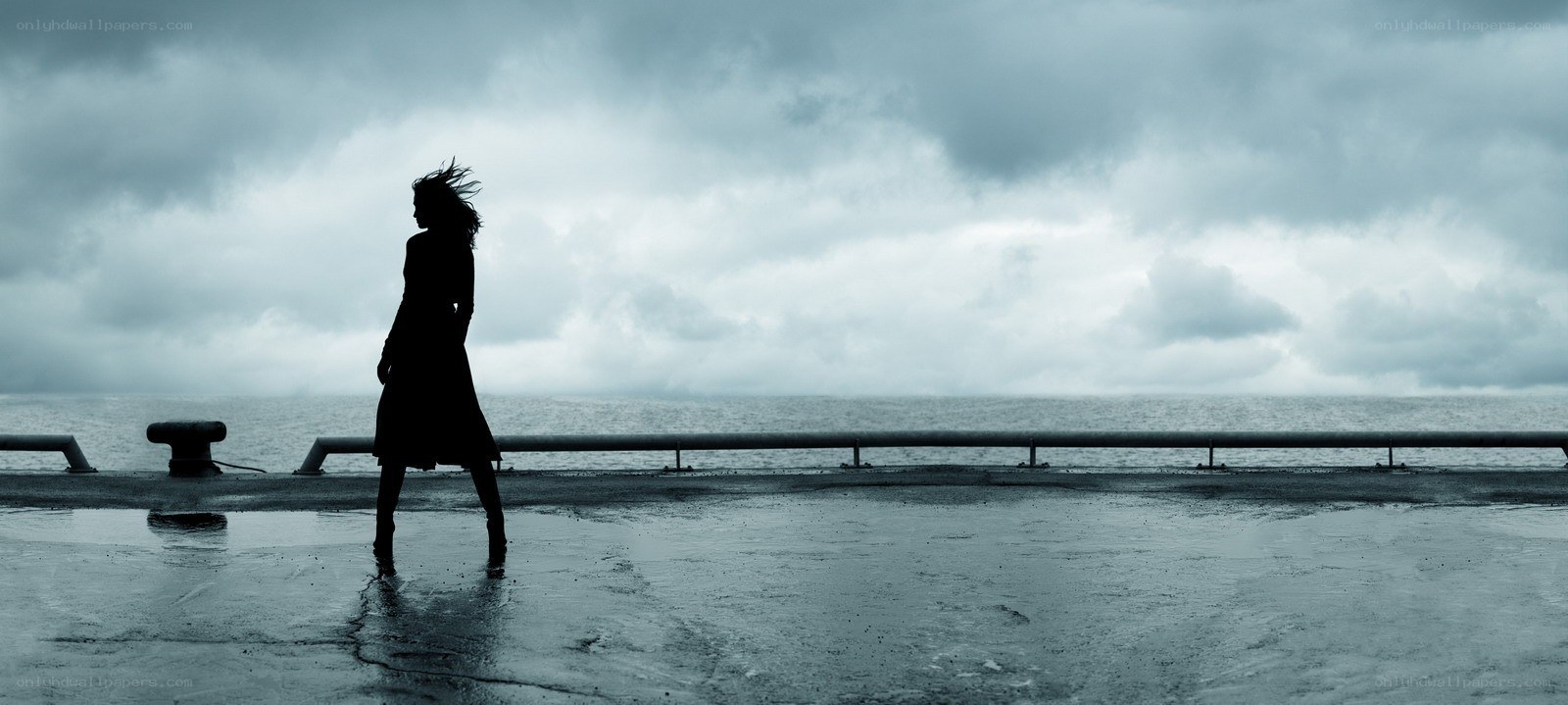 Silhouette on a stormy pier