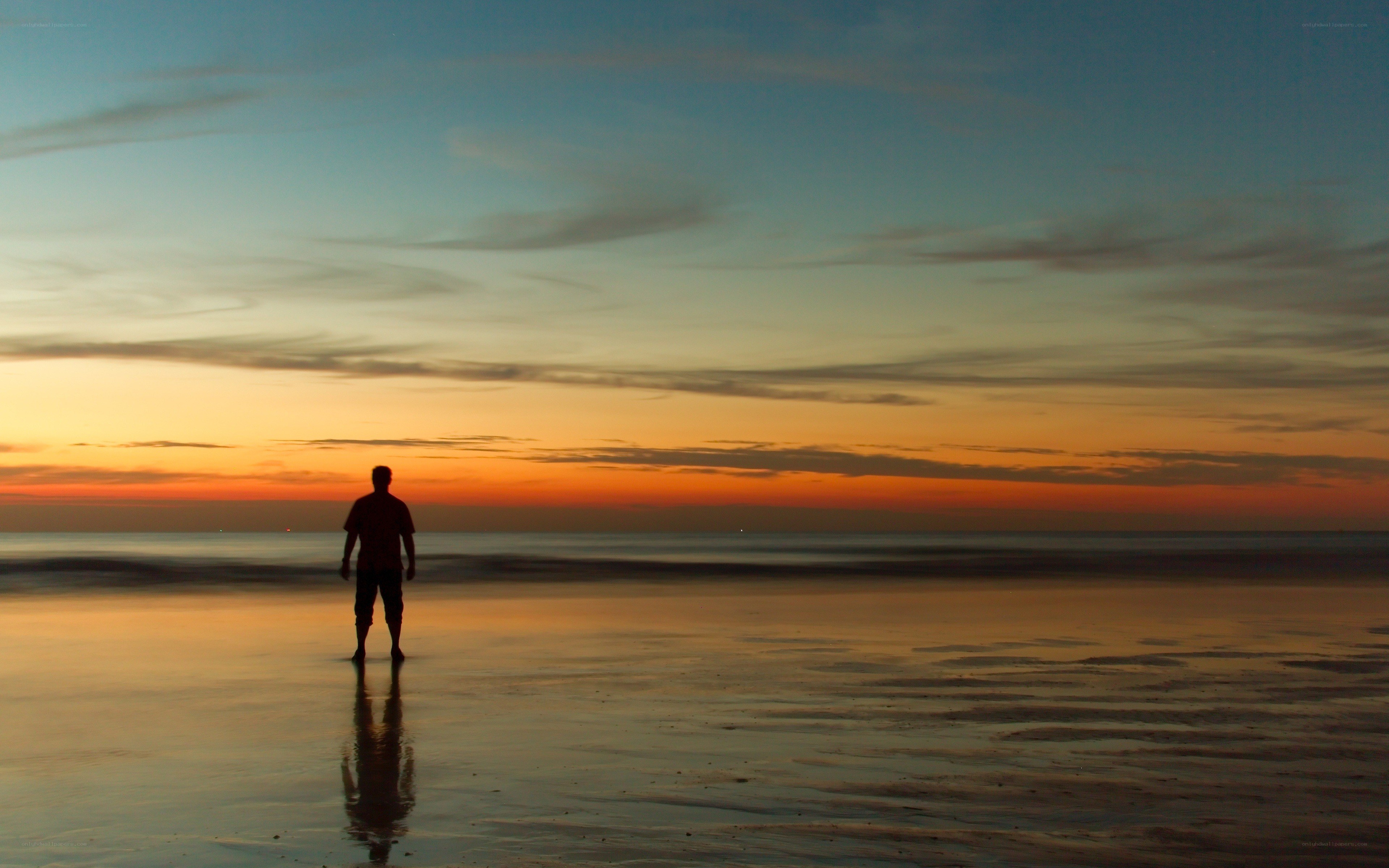 Silhouette on beach at sunset