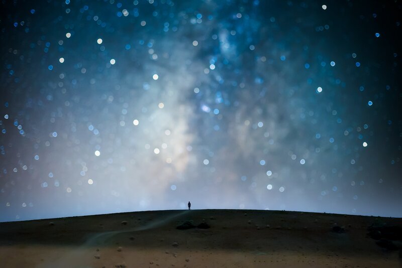 Silhouette on Hill under Stars