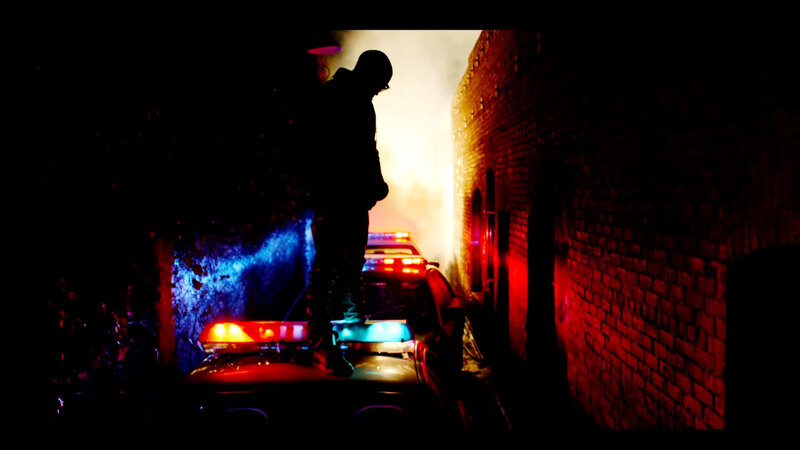 Silhouette on police car at night