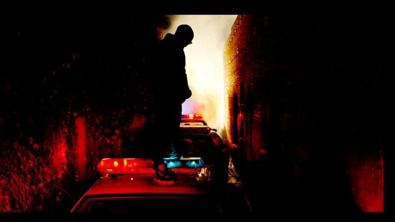 Silhouette on police car at night