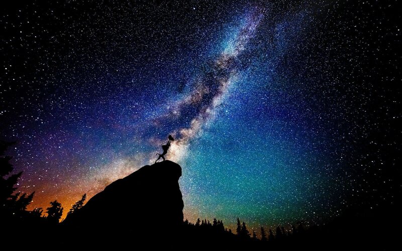 Silhouette on Rock under Stars