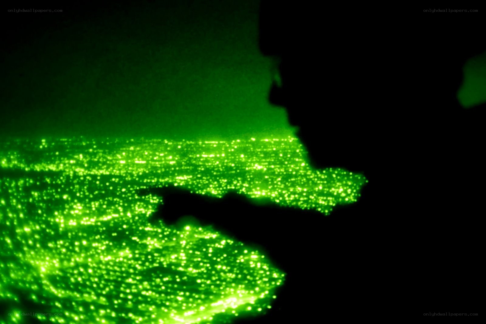 silhouette pointing at glowing green particles