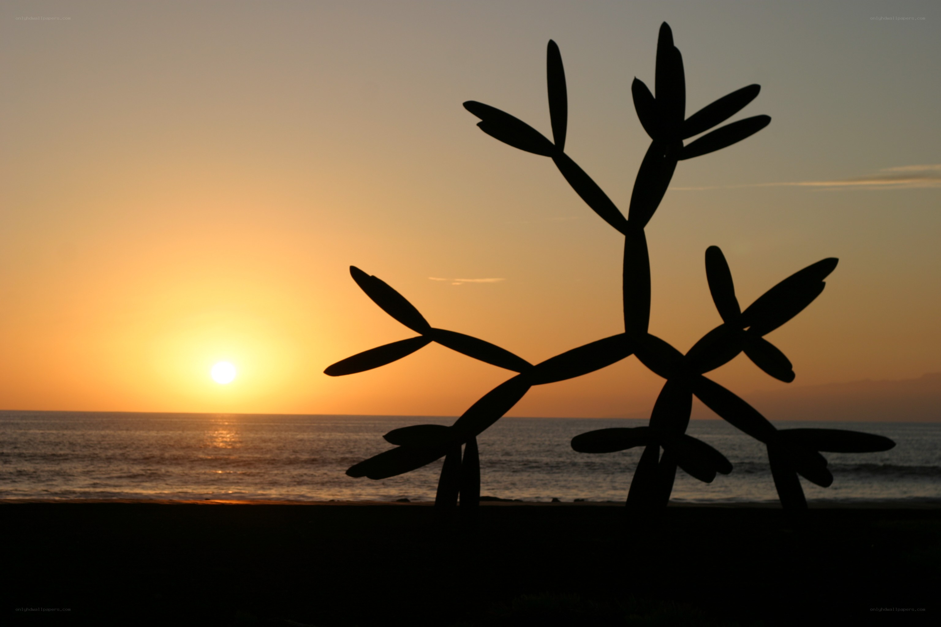 silhouette sculpture at sunset