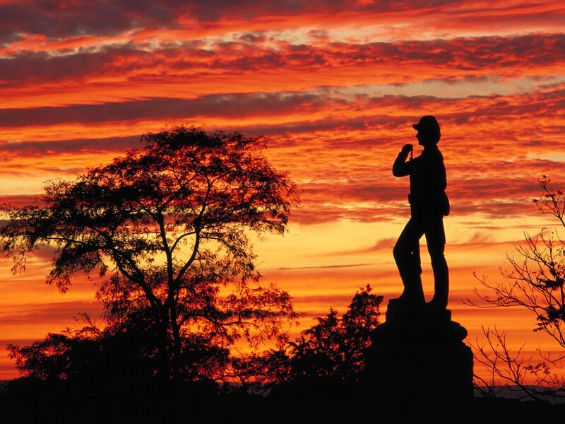 Silhouette statue at sunset