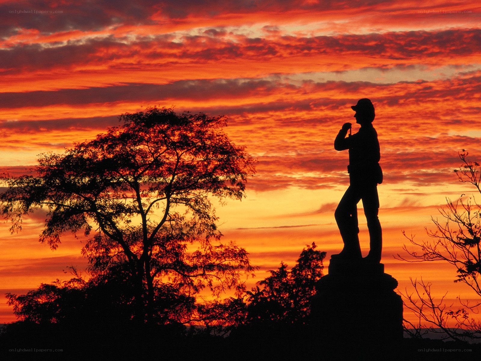 Silhouette statue at sunset