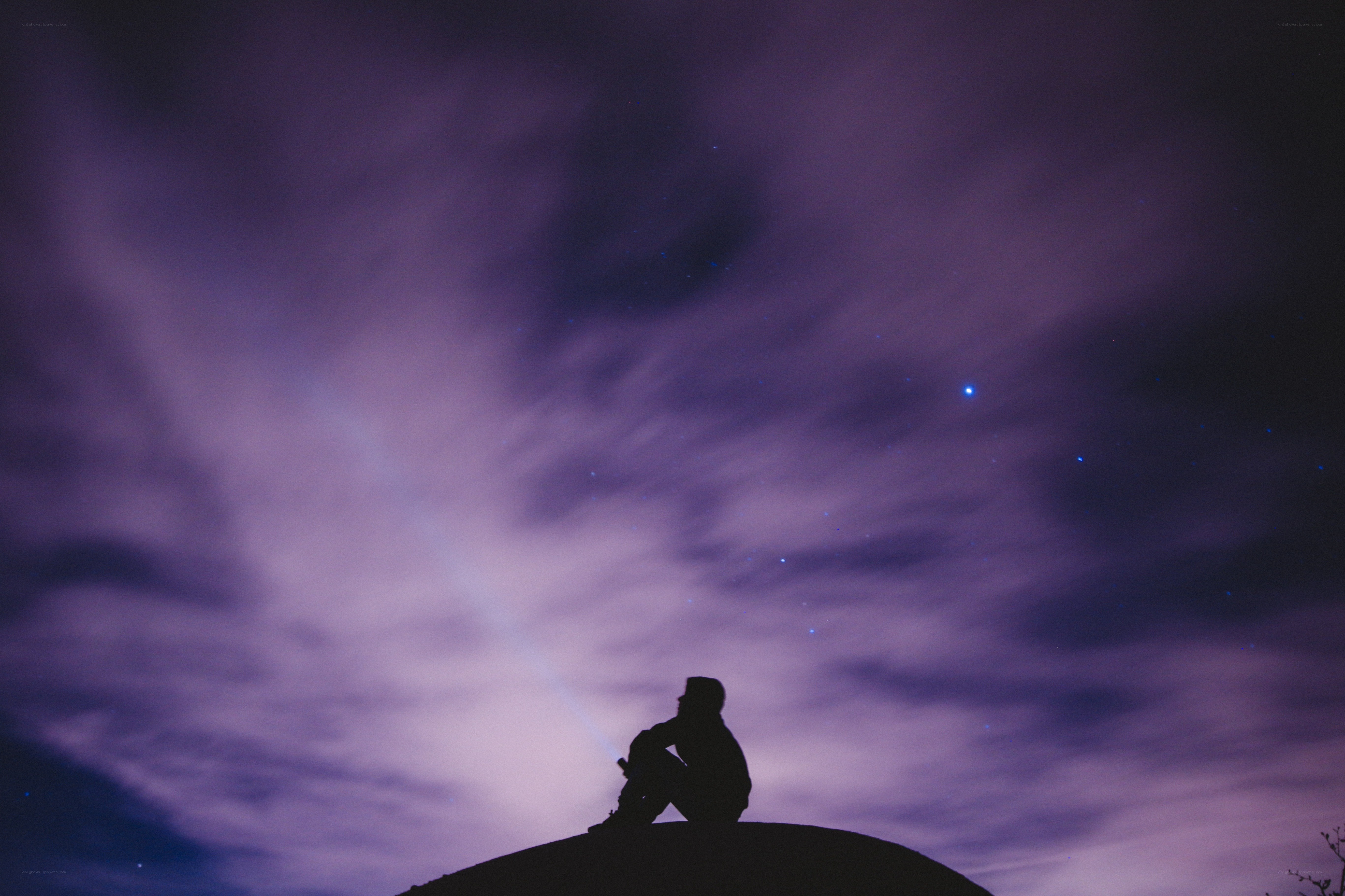 Silhouette under starry sky