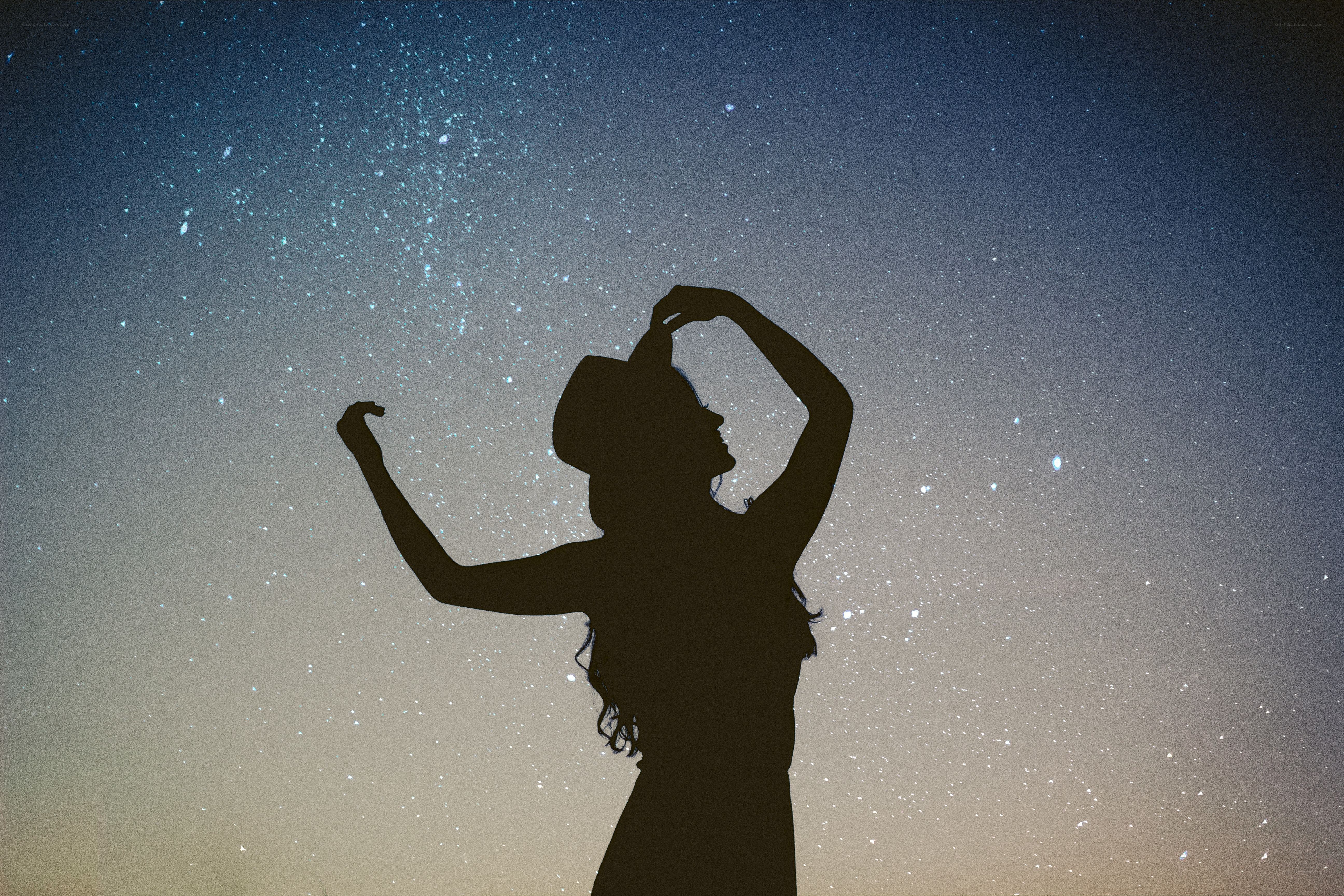 Silhouette under starry sky