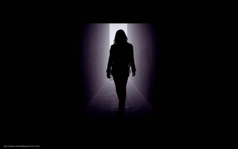 silhouette walking down hallway