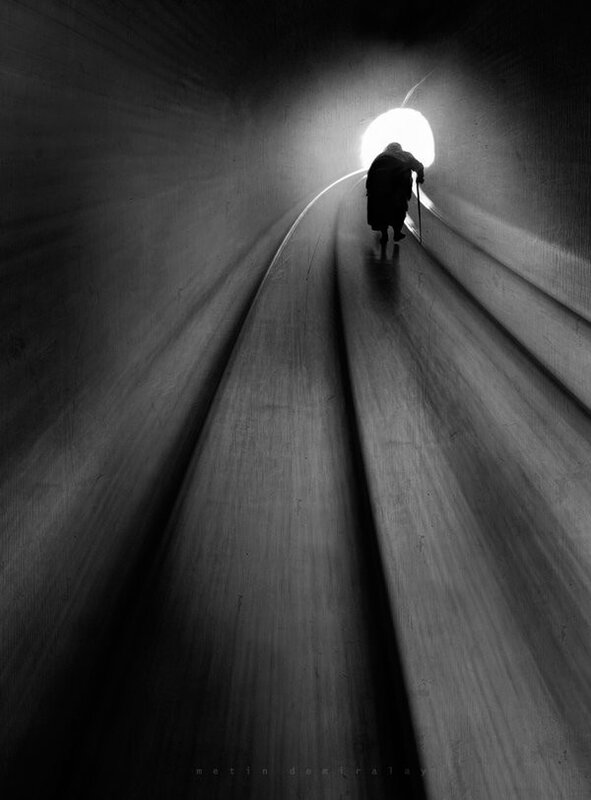 silhouette walking through tunnel