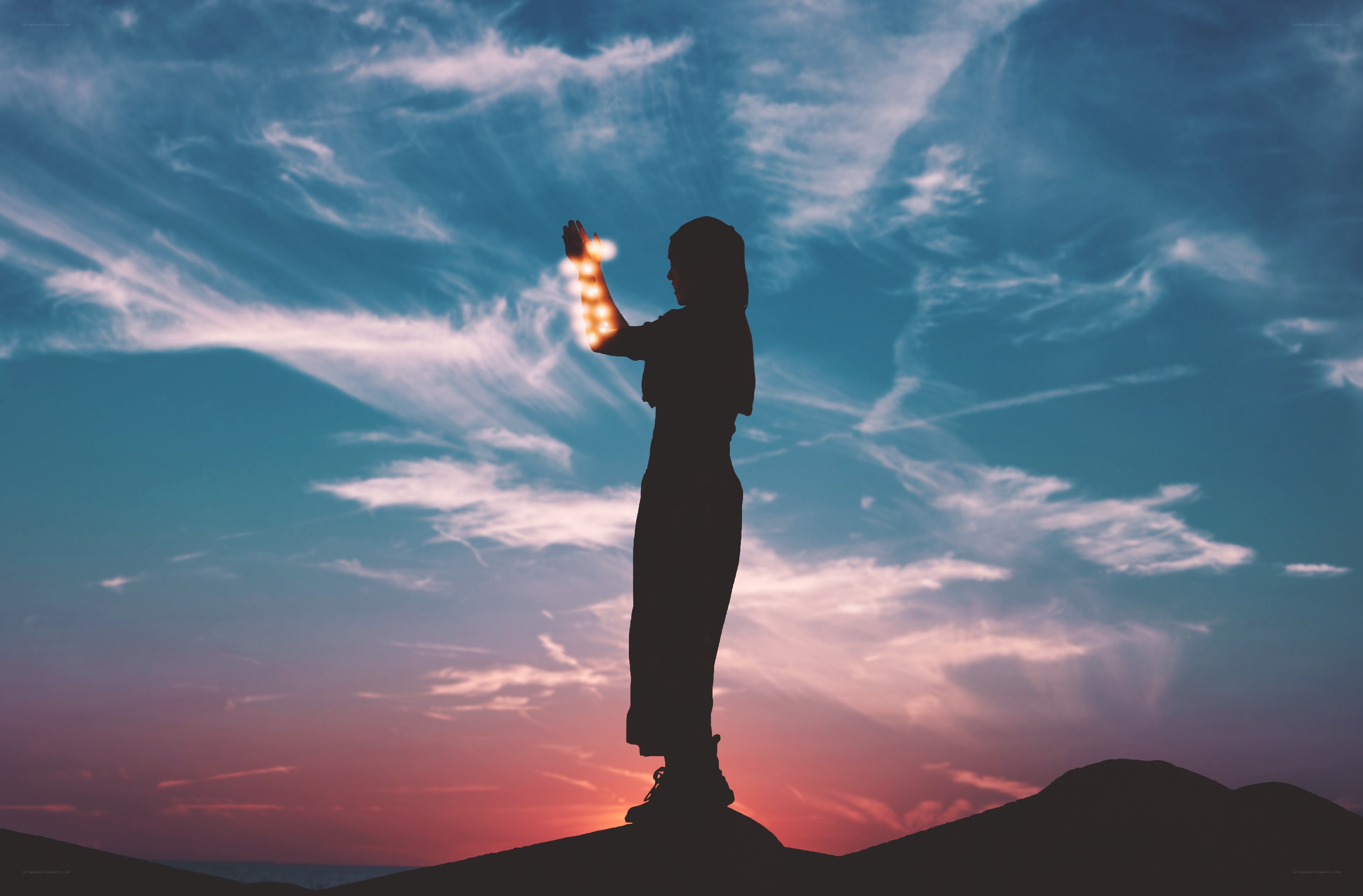 silhouette with glowing hand