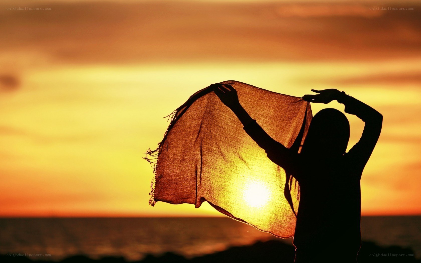 Silhouette with scarf at sunset