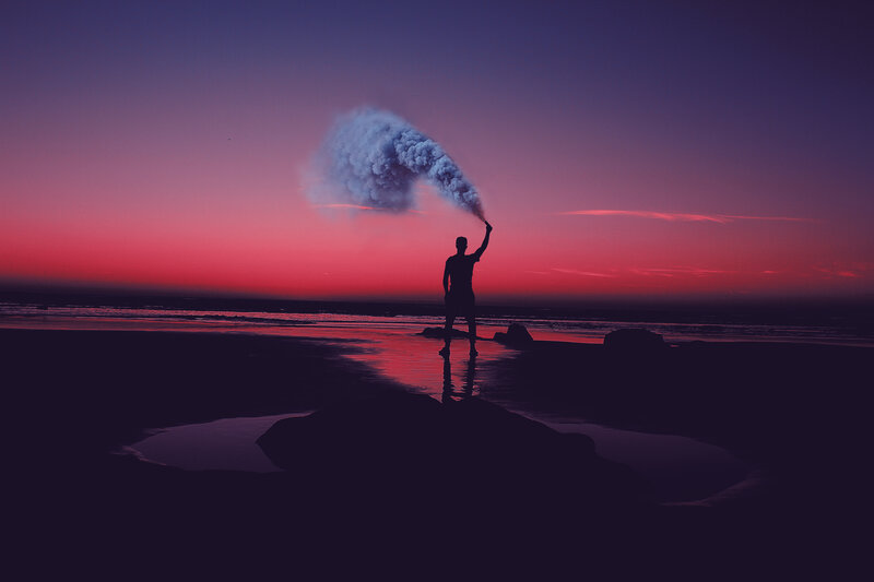 Silhouette with smoke on beach