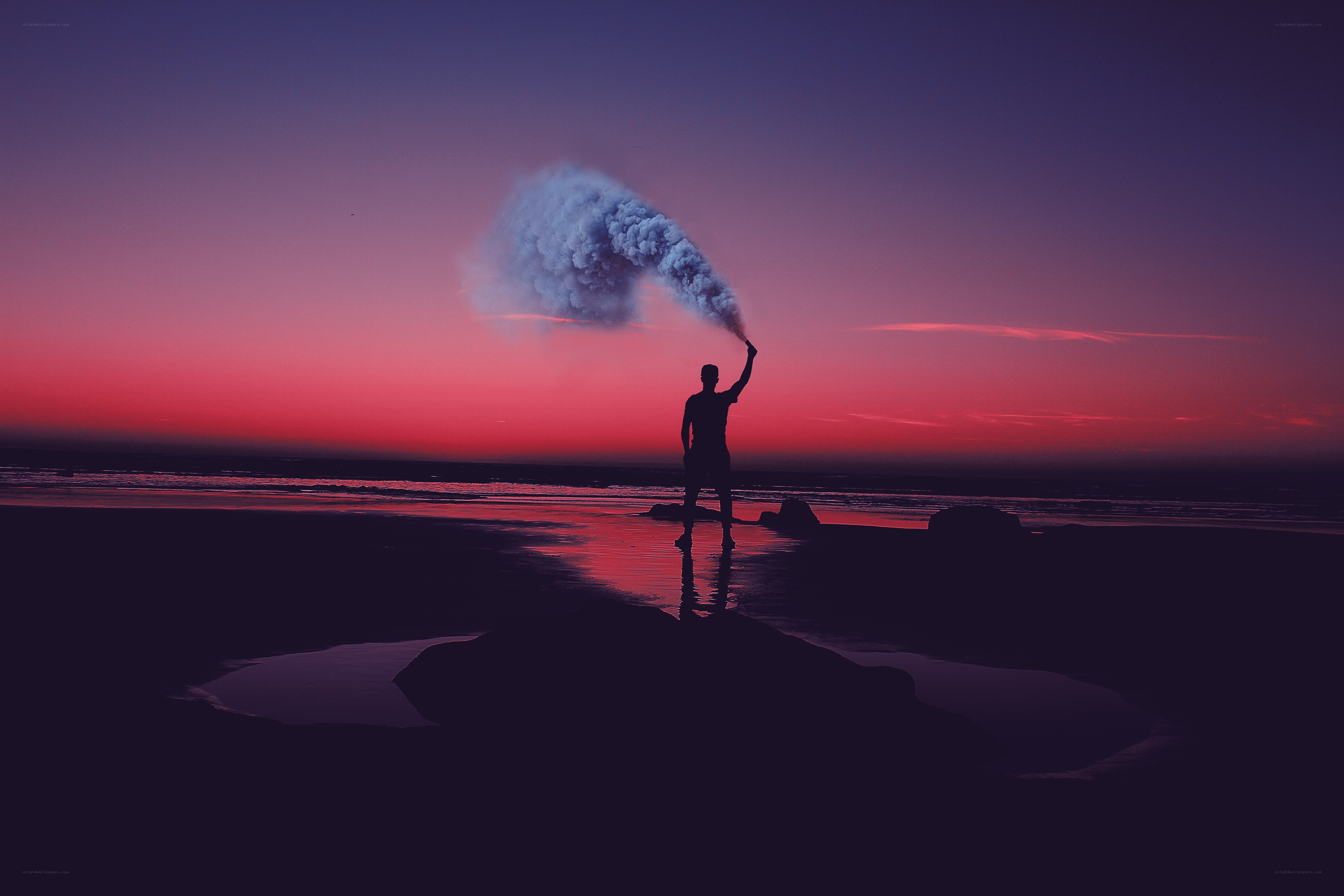 Silhouette with smoke on beach