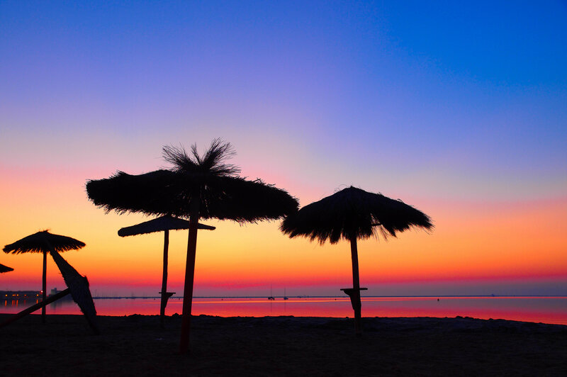 Silhouetted Beach Umbrellas — Blue