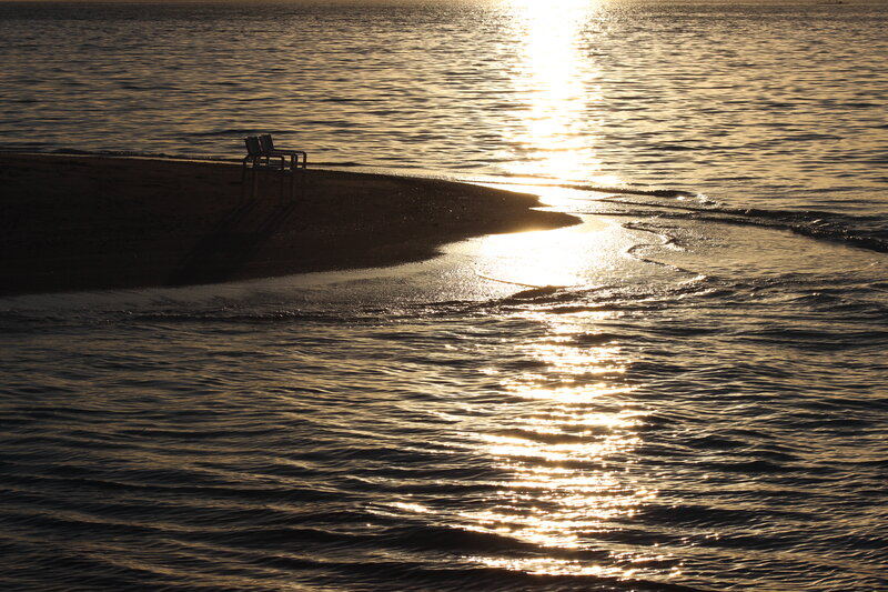 Silhouetted Bench on Beach