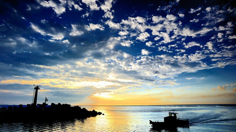 Silhouetted Boat at Sunset — Blue