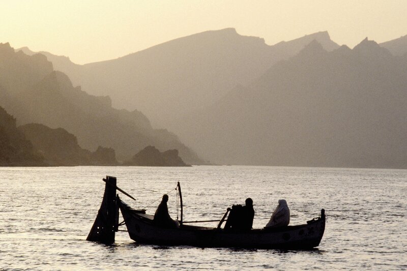 Silhouetted boat on calm water