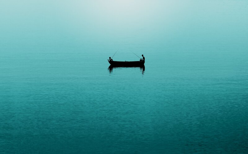 Silhouetted boat on calm water