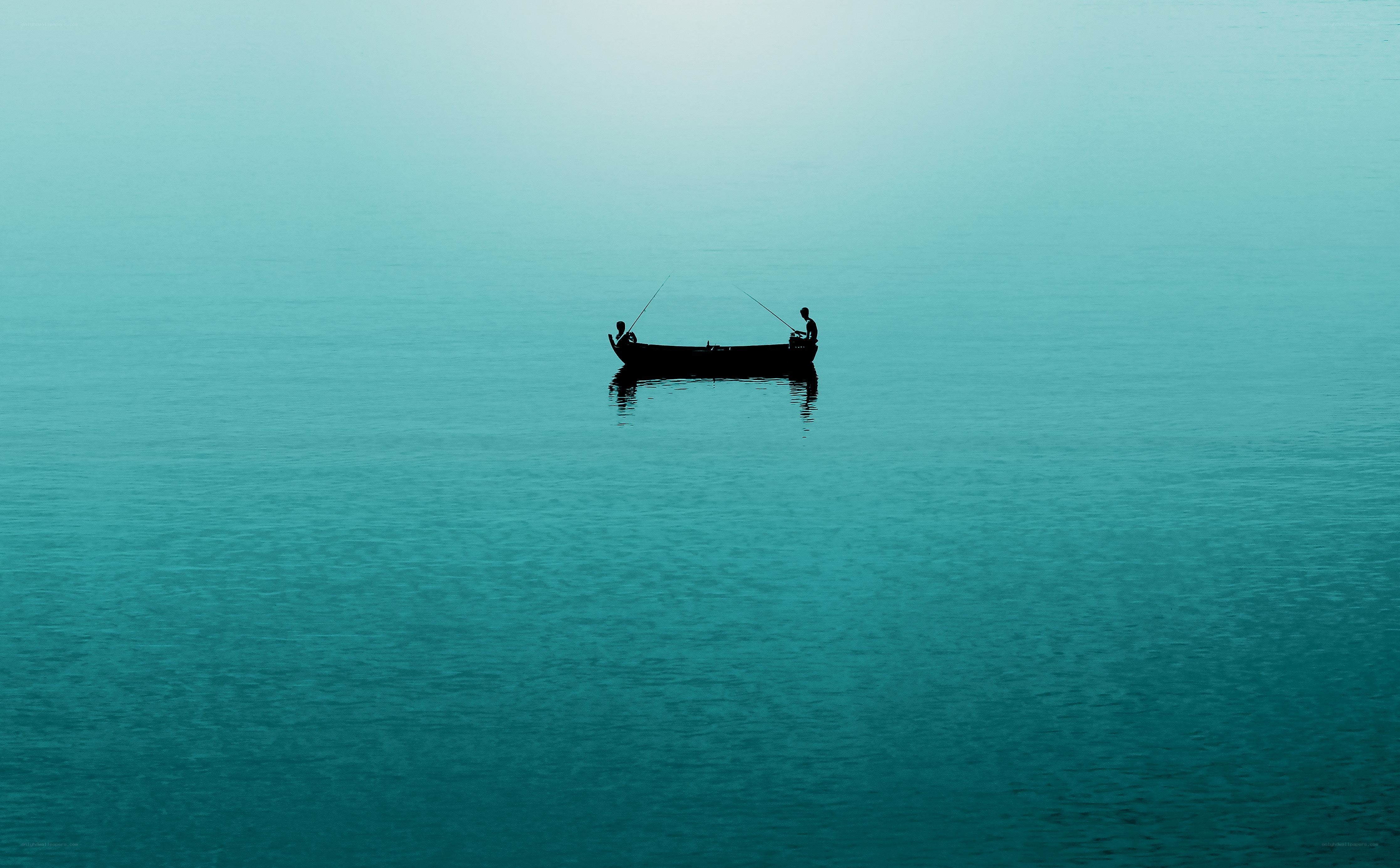 Silhouetted boat on calm water