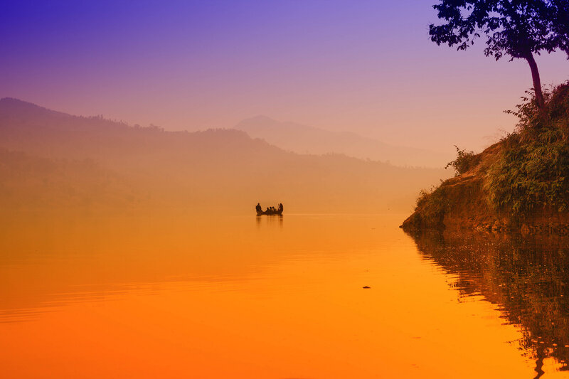 Silhouetted Boat on Lake — Orange