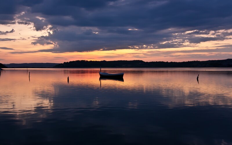 Silhouetted Boat on Lake
