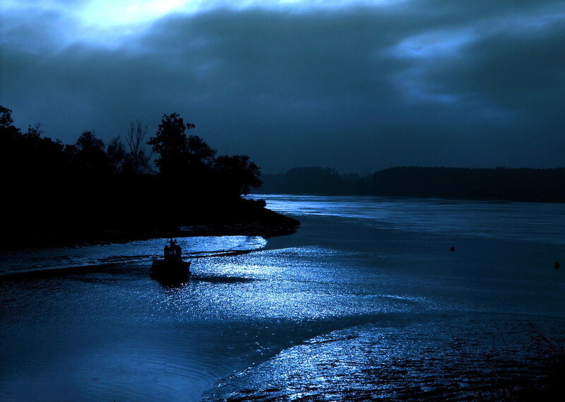 Silhouetted Boat on River