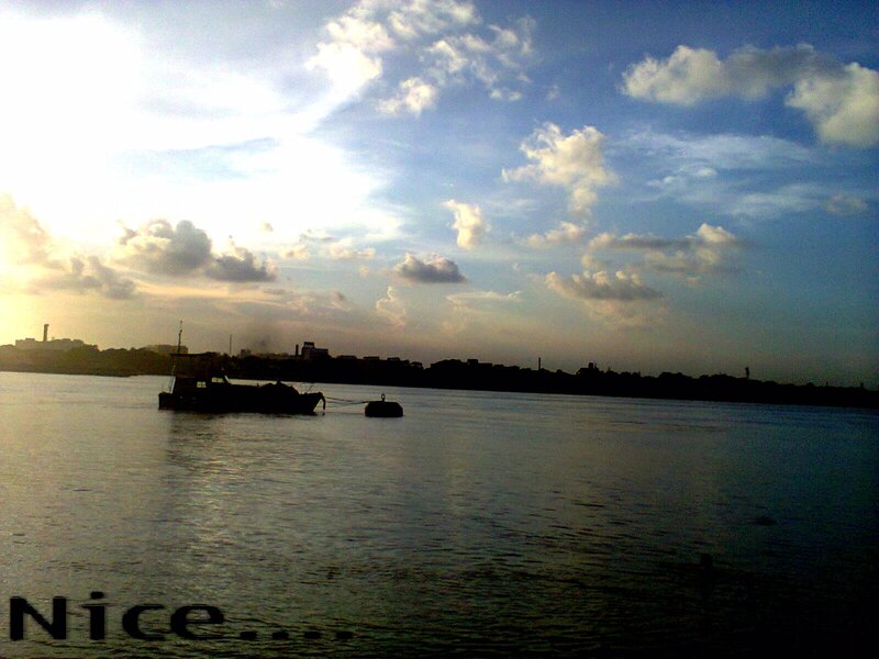 Silhouetted Boat on Water — Blue