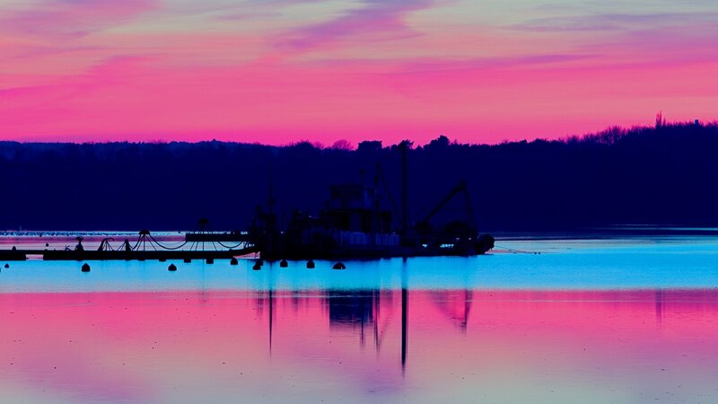 Silhouetted Boat on Water — Pink